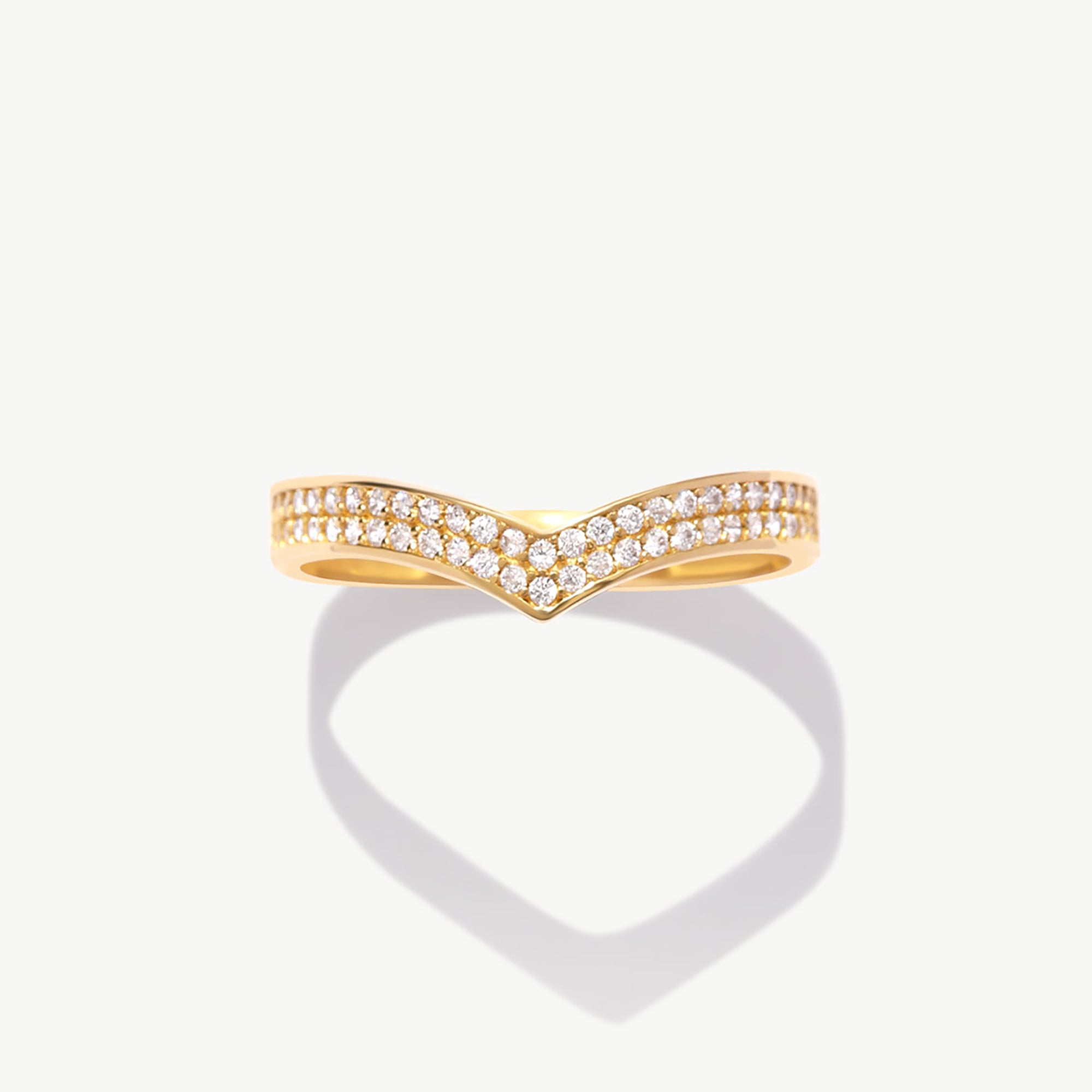 Yellow gold diamond wishbone eternity ring photographed front facing on a white background emphasizing the symmetrical V shaped pavé design.