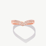 Rose gold wishbone eternity band featuring natural pavé diamonds photographed front facing with a soft heart-shaped shadow reflection.