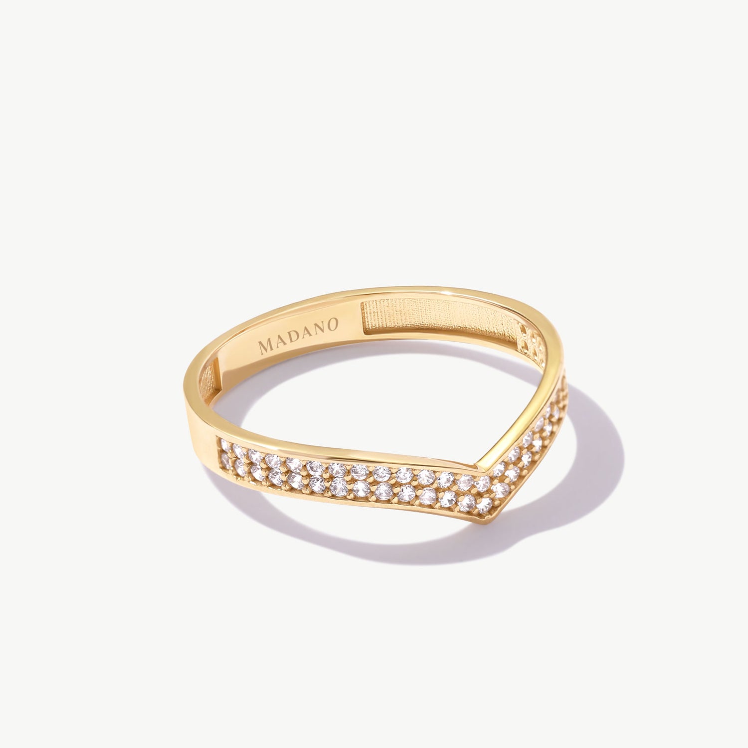 14K solid gold diamond wishbone eternity ring featuring 56 natural pavé set round diamonds arranged along a minimalist V shaped wedding band on a white background.