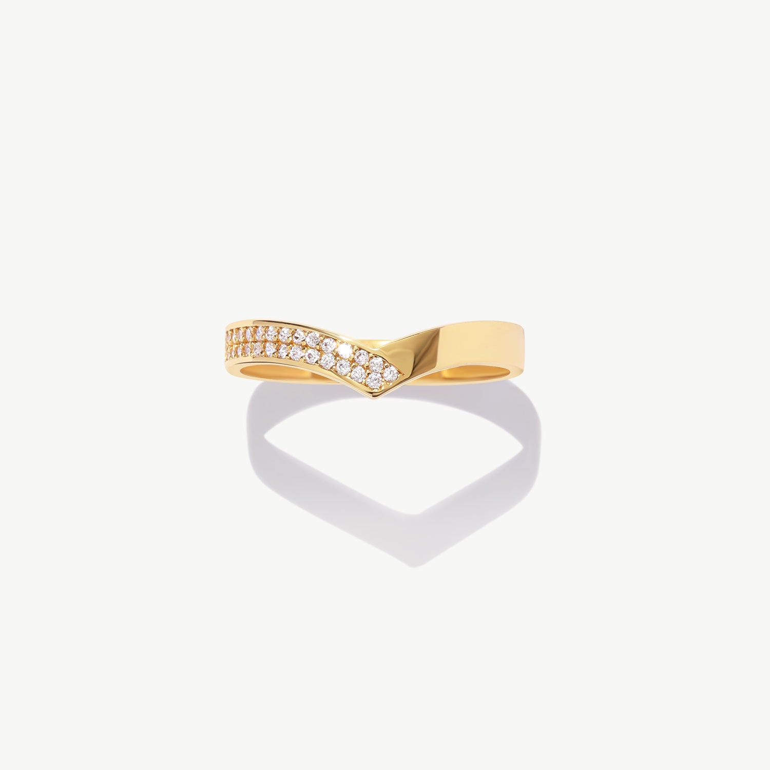 14K solid gold diamond half eternity wishbone ring featuring natural pavé set round diamonds arranged along a refined V shaped wedding band silhouette on a white background.