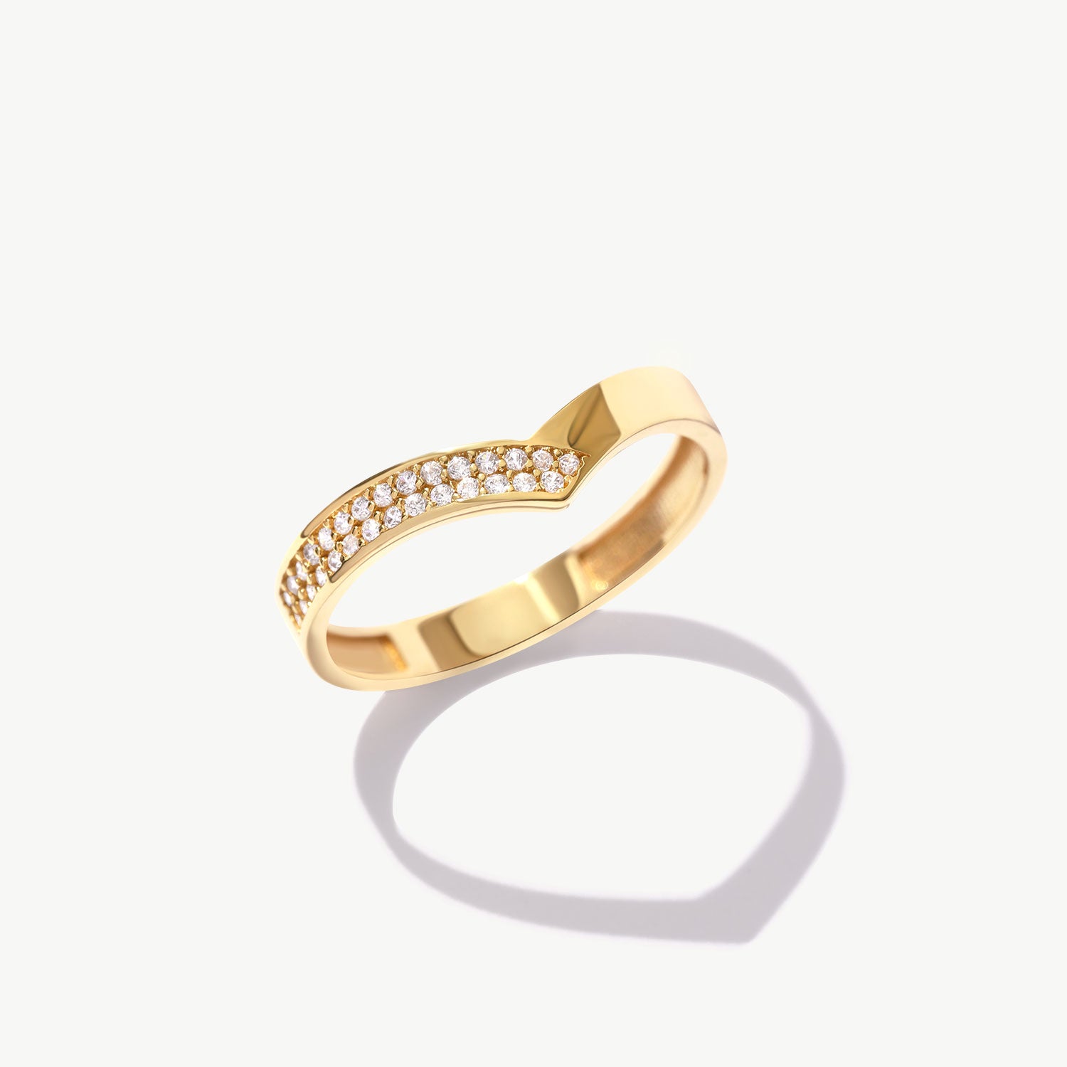 Product photograph of a yellow gold pavé diamond V shaped ring featuring natural round brilliant diamonds and a polished solid gold band.