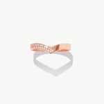 Rose gold diamond half eternity wishbone ring featuring pavé set natural diamonds photographed on a white background with a soft heart shaped shadow reflection.