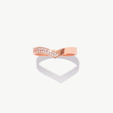 Rose gold diamond half eternity wishbone ring featuring pavé set natural diamonds photographed on a white background with a soft heart shaped shadow reflection.