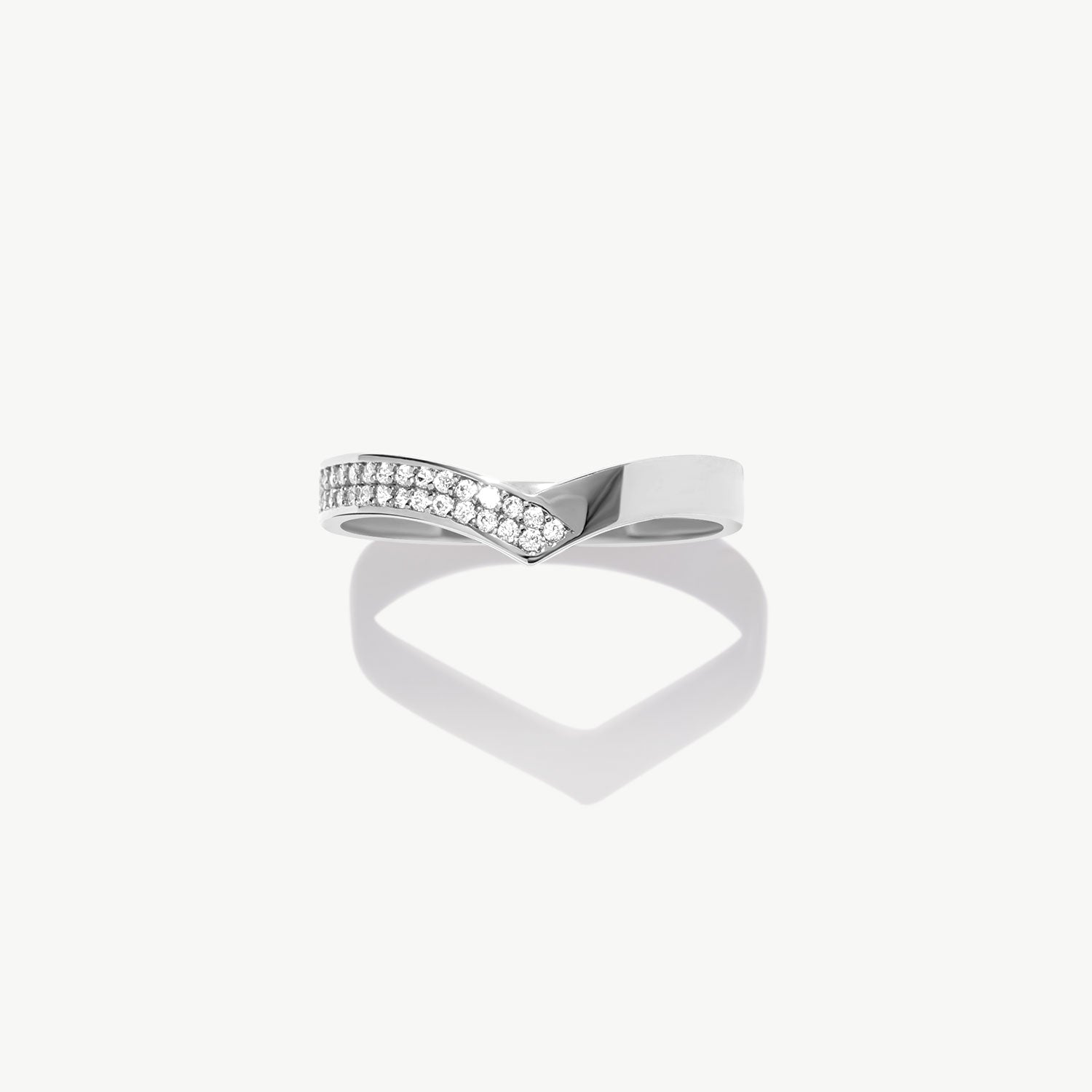 White gold half eternity wishbone ring featuring pavé set natural round diamonds arranged in a V shaped bridal band design.