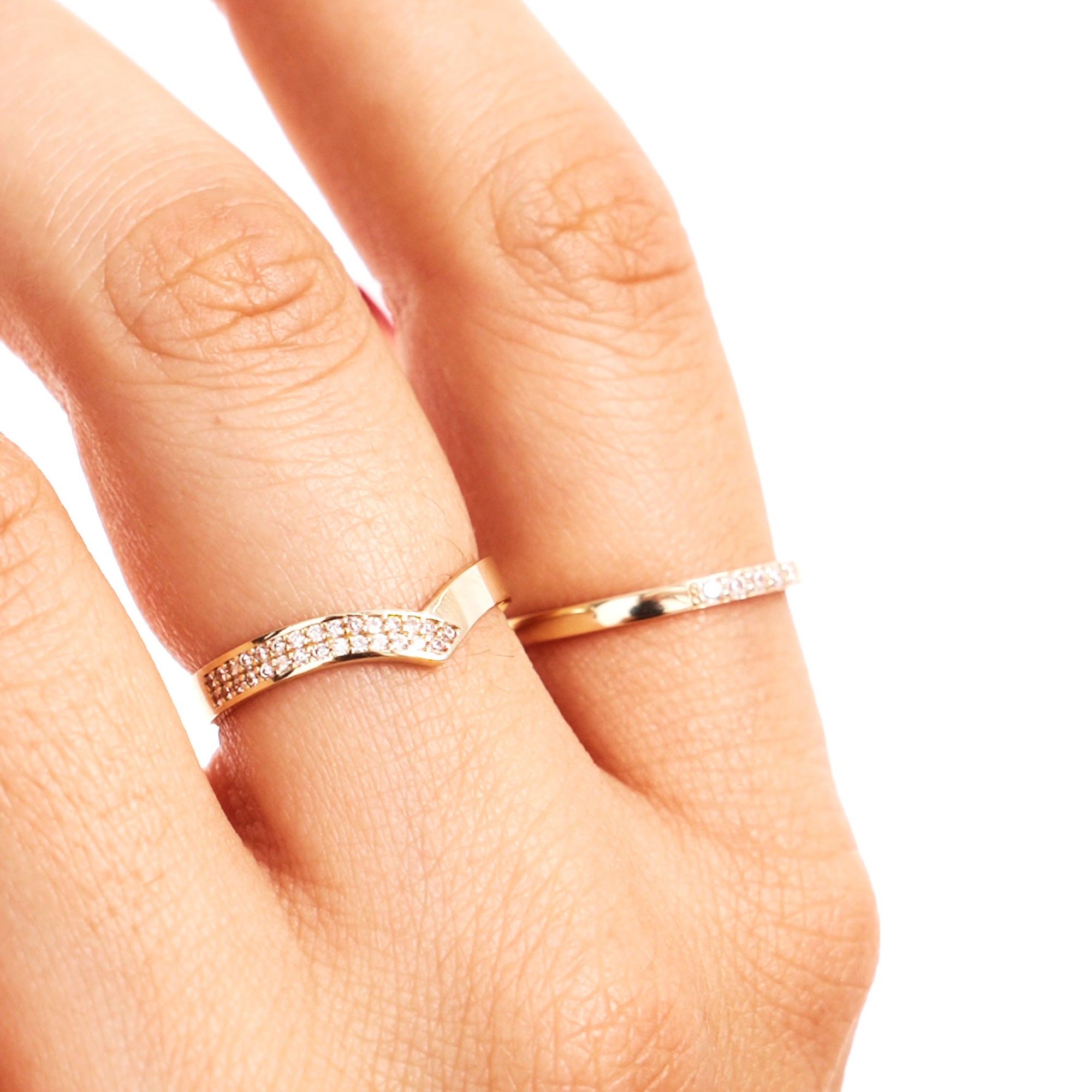 Close-up hand image of a woman wearing a minimalist diamond wishbone promise ring crafted from genuine 14K solid gold.