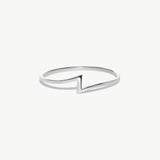 White gold minimalist lightning bolt ring photographed on a white background showcasing the thin geometric thunder bolt design.