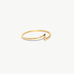 Delicate yellow gold lightning bolt stacking ring photographed on a white background emphasizing the ultra-thin polished band.