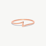 Rose gold lightning bolt ring photographed on a white background showcasing the clean geometric zigzag silhouette.