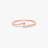 Rose gold lightning bolt ring photographed on a white background showcasing the clean geometric zigzag silhouette.