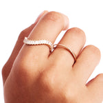 Close Up Of Minimalist Infinity Band Gold Ring On Hand