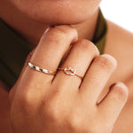 Close Up Of Woman Wearing Delicate Love Knot Gold Ring