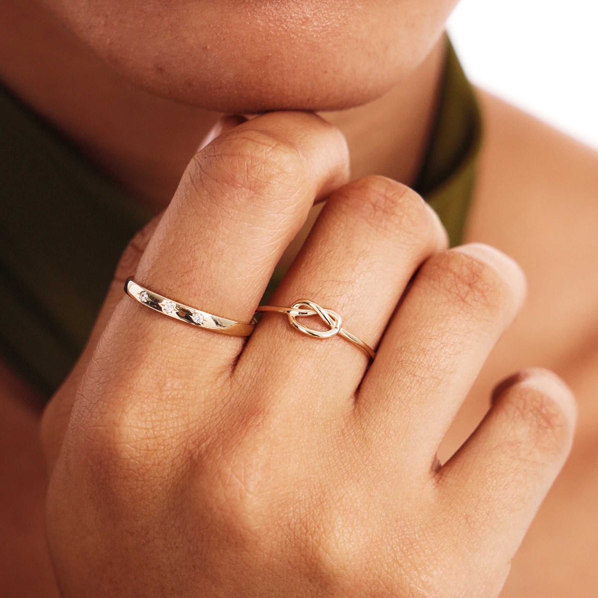 Close Up Of Woman Wearing Delicate Love Knot Gold Ring