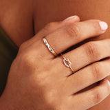 Close Up Of Delicate 14K Solid Gold Knot Ring On Hand