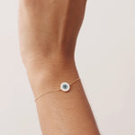 14K Real Solid Gold Evil Eye Bracelet with a white enamel charm, symbolizing protection and good fortune. Adjustable chain for a secure fit, perfect for daily wear.
