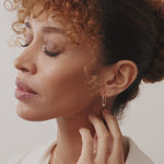 14K gold beaded hoop earrings with lever-back clasp, featuring delicate gold beads for added charm and elegance, perfect for both everyday wear and special occasions.