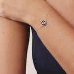 14K Real Solid Gold Navy Blue Evil Eye Bracelet with blue enamel charm, representing protection and good luck, with an adjustable gold chain for a secure fit.